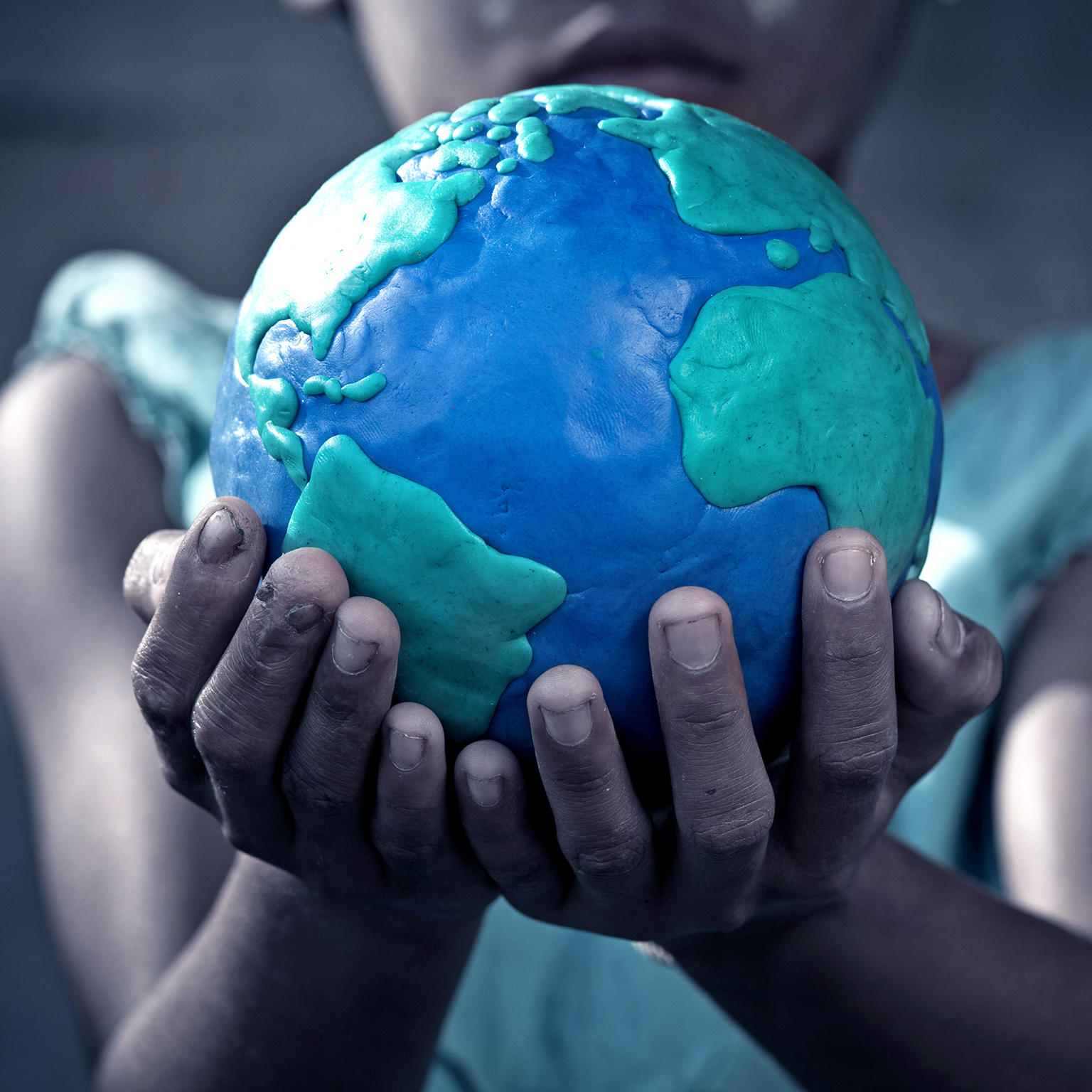 Young girl holding a globe in her hands
