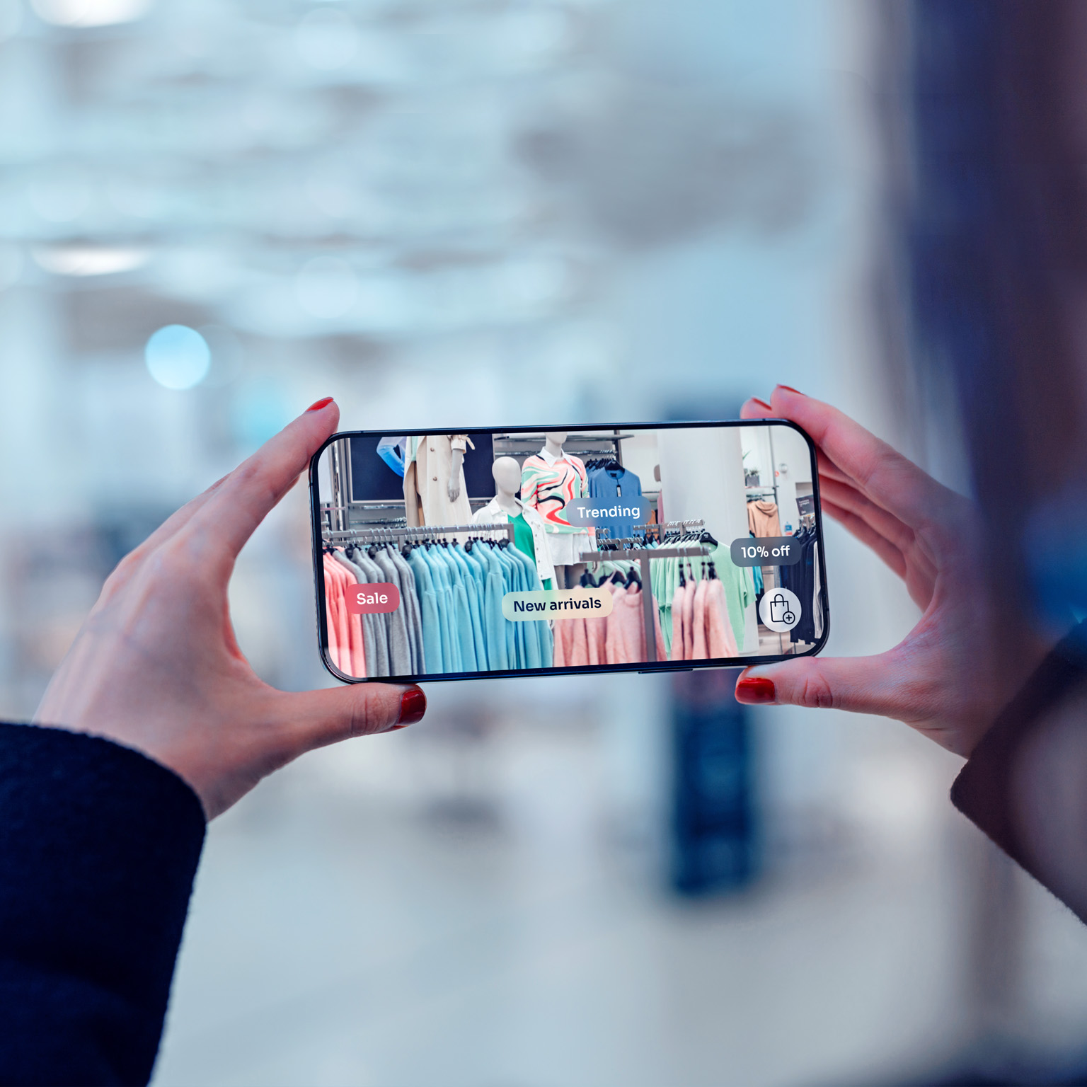 Female hand holding smartphone using augmented reality application to check special sale price in retail fashion store.