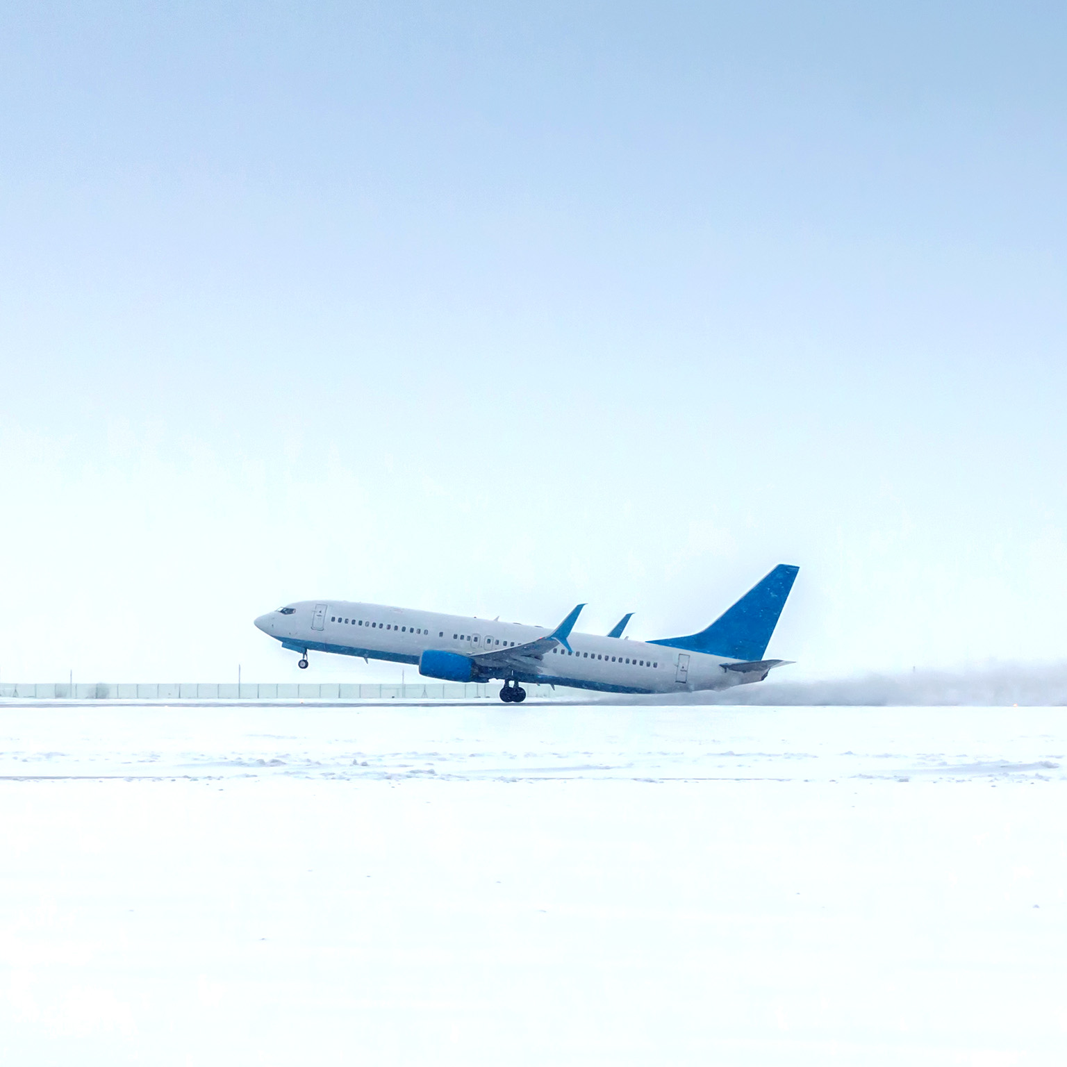 Takeoff of a passenger jet plane in a severe snowstorm