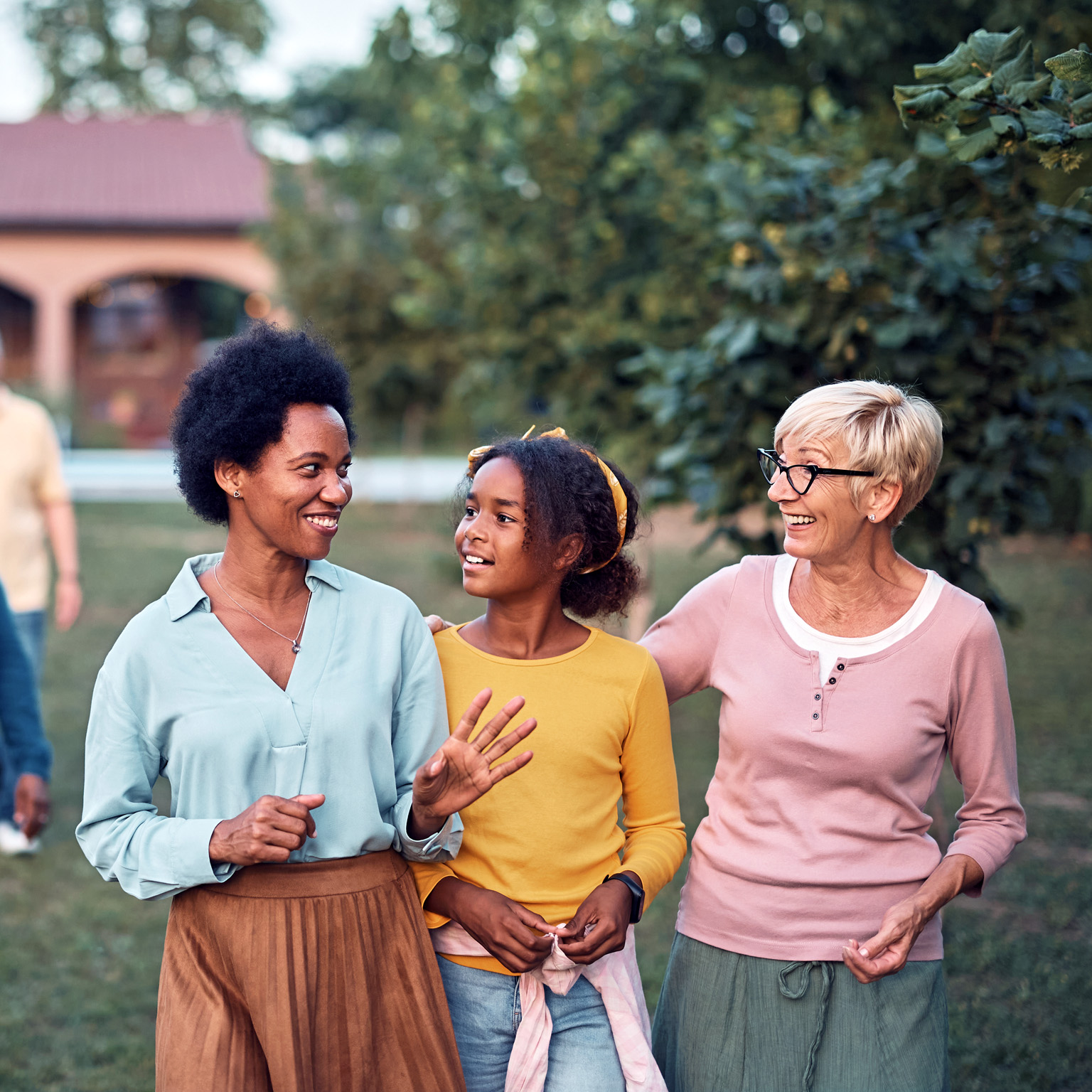 Happy multiethnic family enjoying while taking a walk in the backyard