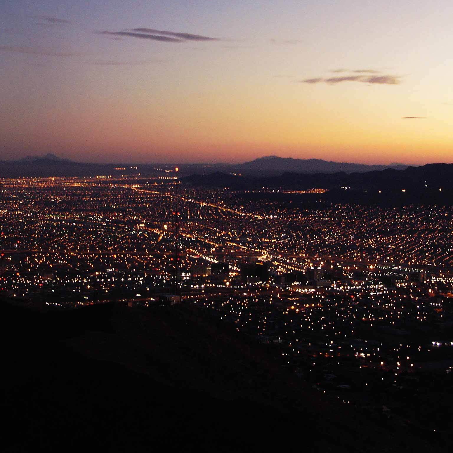 City illuminated at dusk showing electrical power grid distribution