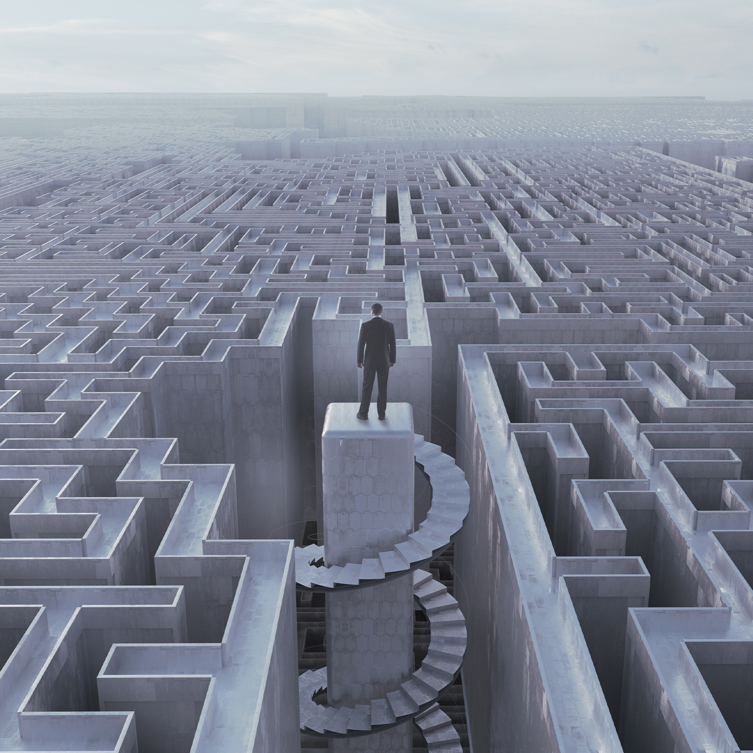 Businessman stranded at top of complex maze - stock photo