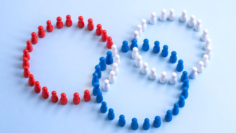 Three coloured rings form by wooden figure overlapping on coloured background.