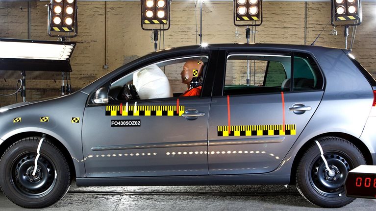 Automotive crash test with test dummy and measurement sensors