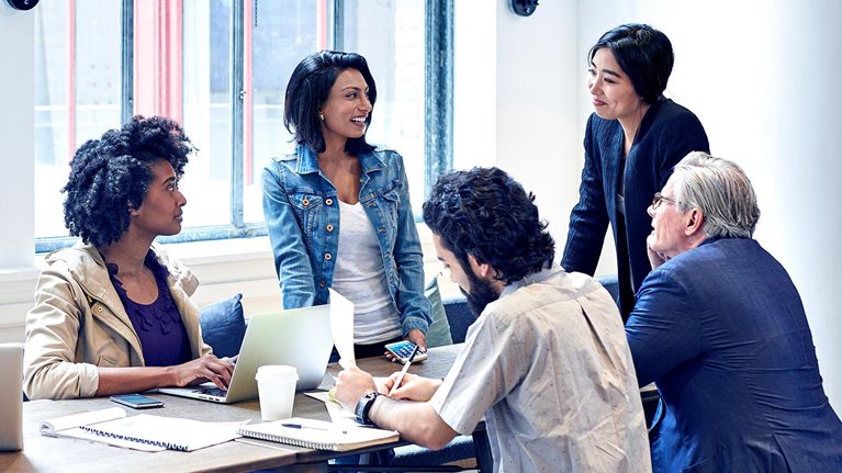 Diverse group of business people having discussion during meeting in office