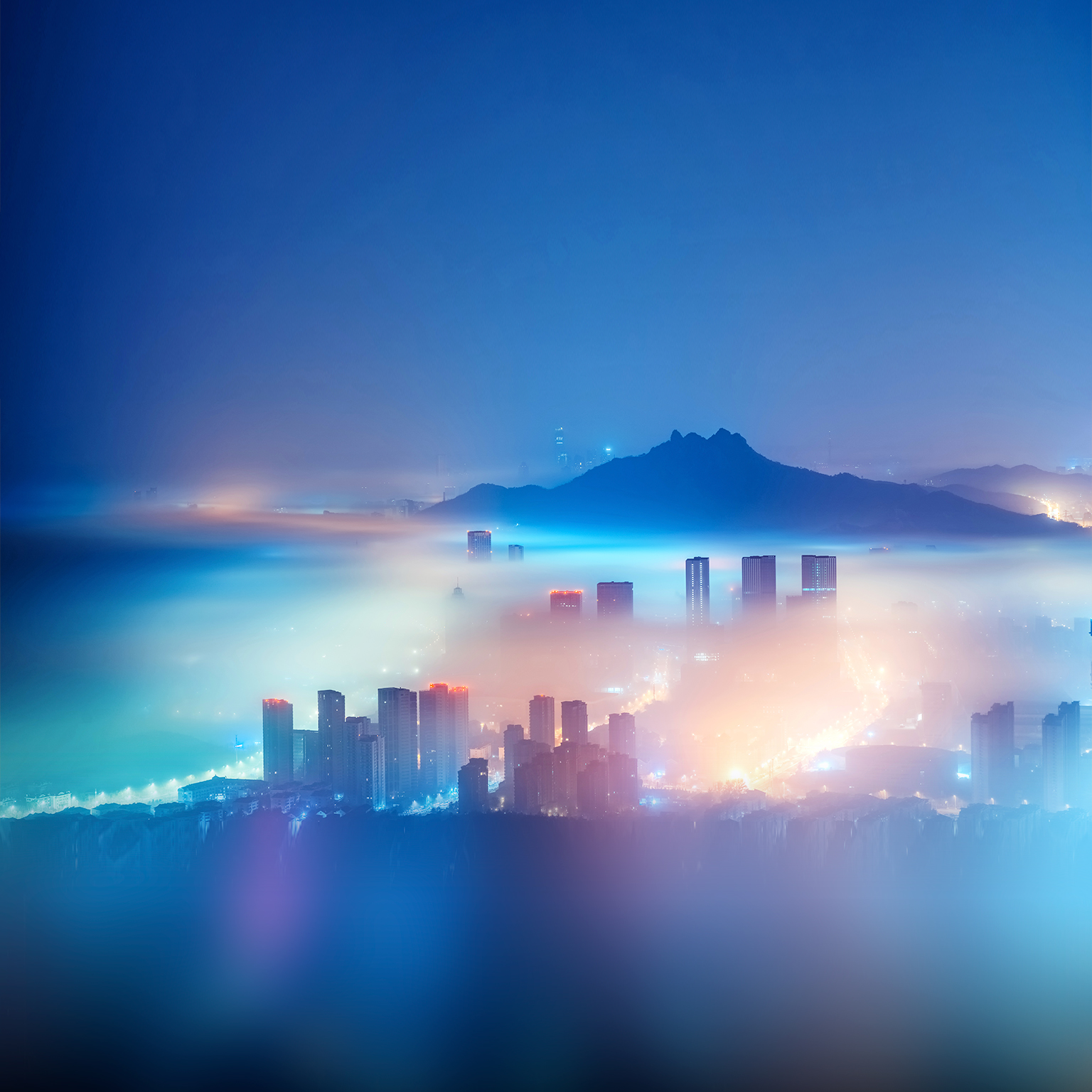 City in the mist at night - stock photo