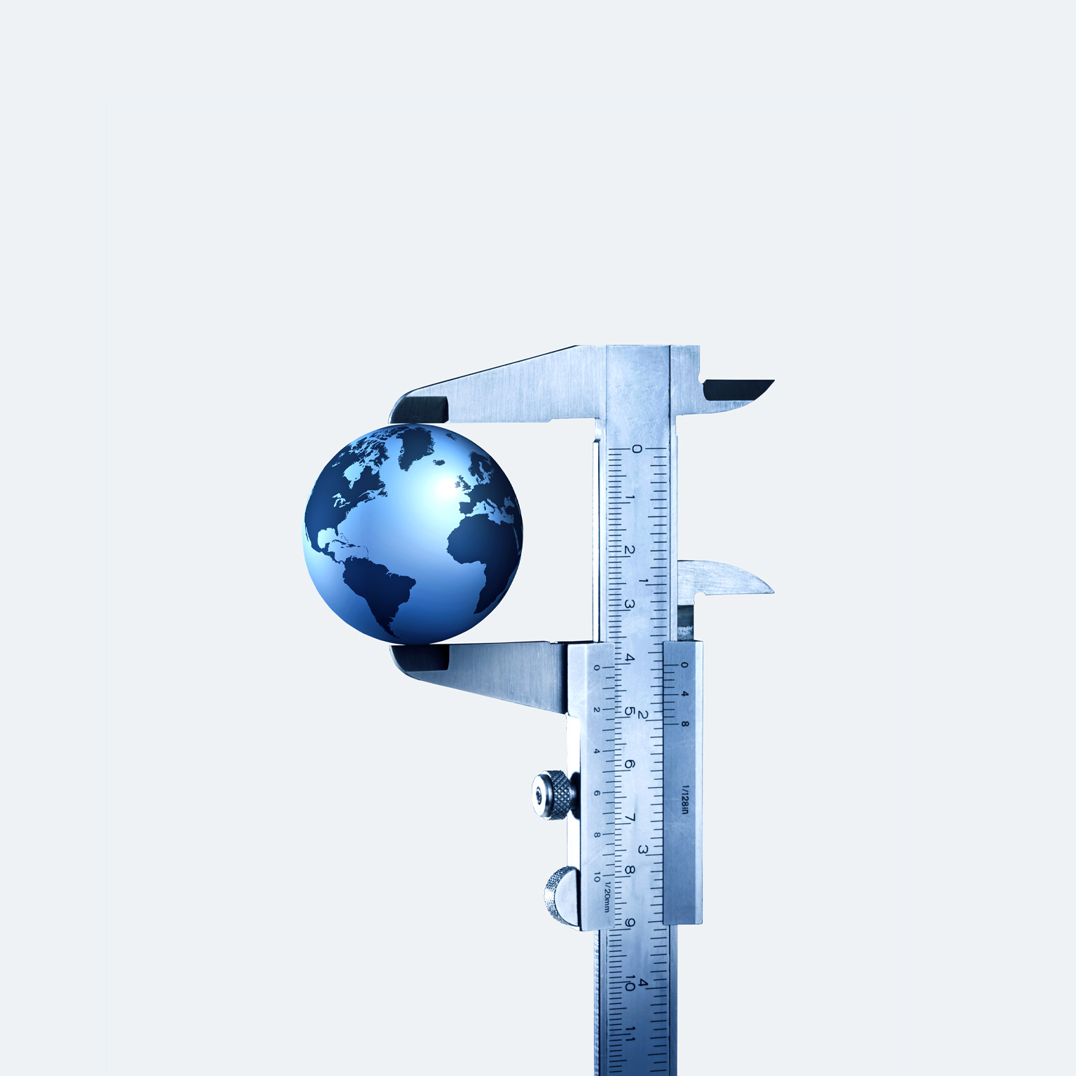 A globe in a vernier caliper set against a light gray background. 