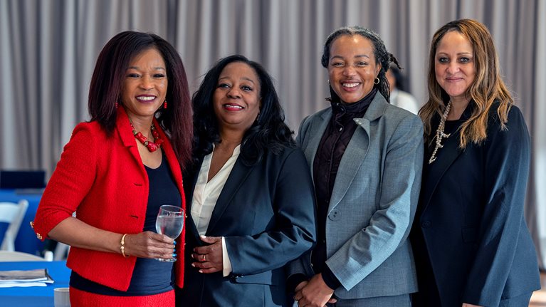 Four healthcare professionals at community partnership event