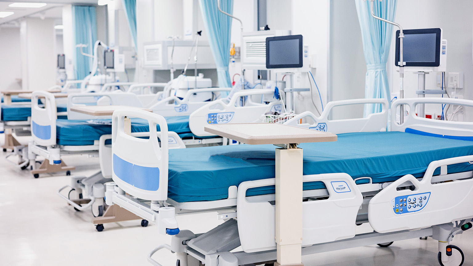 Modern hospital room with adjustable beds and medical monitoring equipment