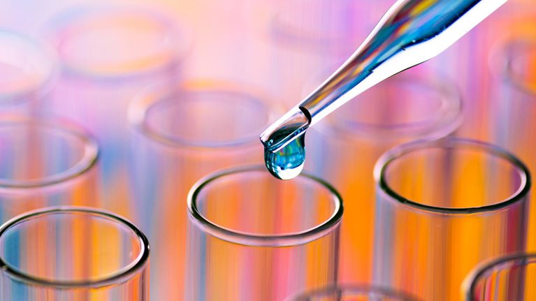 Pipette dispensing liquid into laboratory test tubes for clinical research