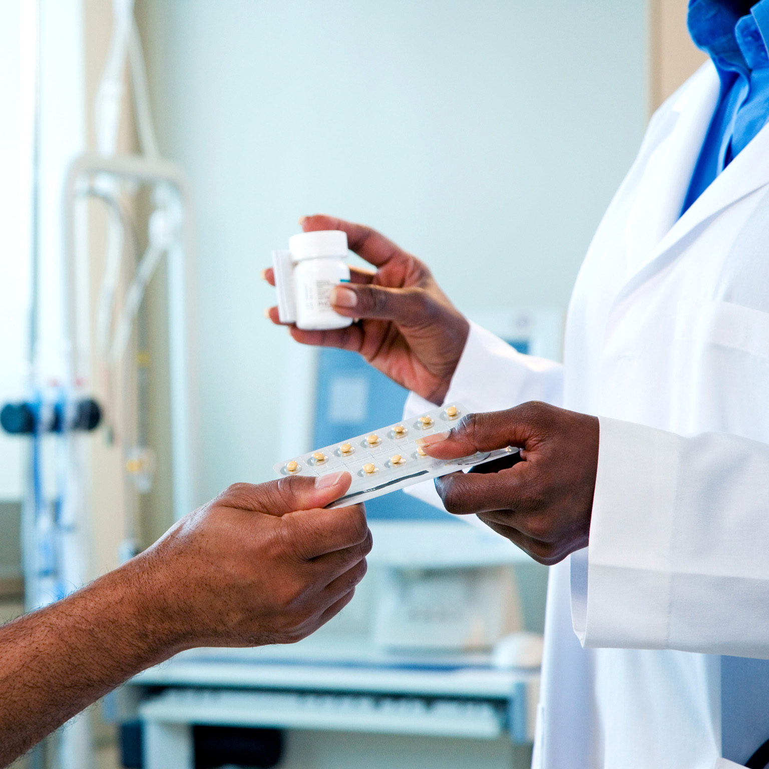 Doctor handing medication to patient