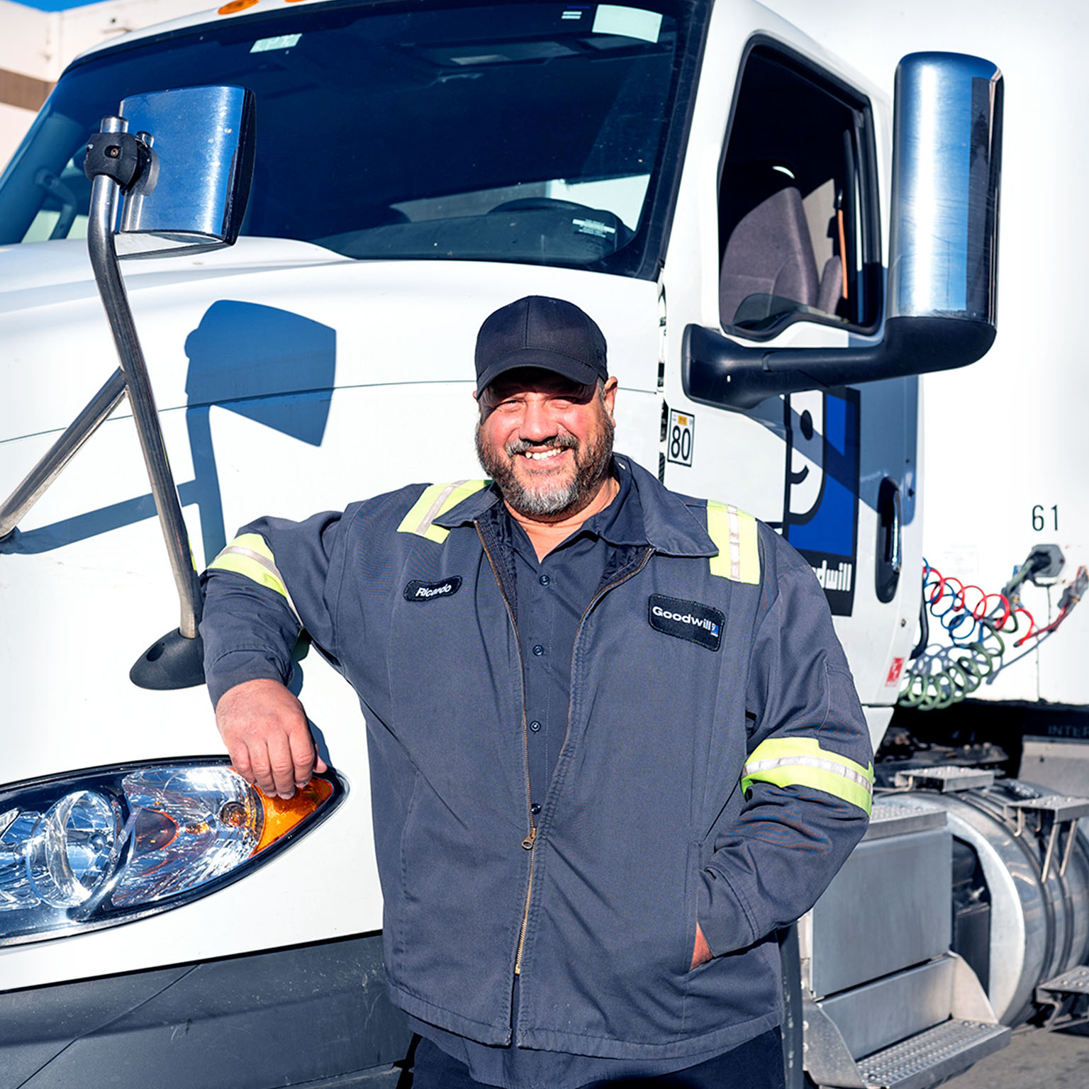 Goodwill employee standing by truck at work location